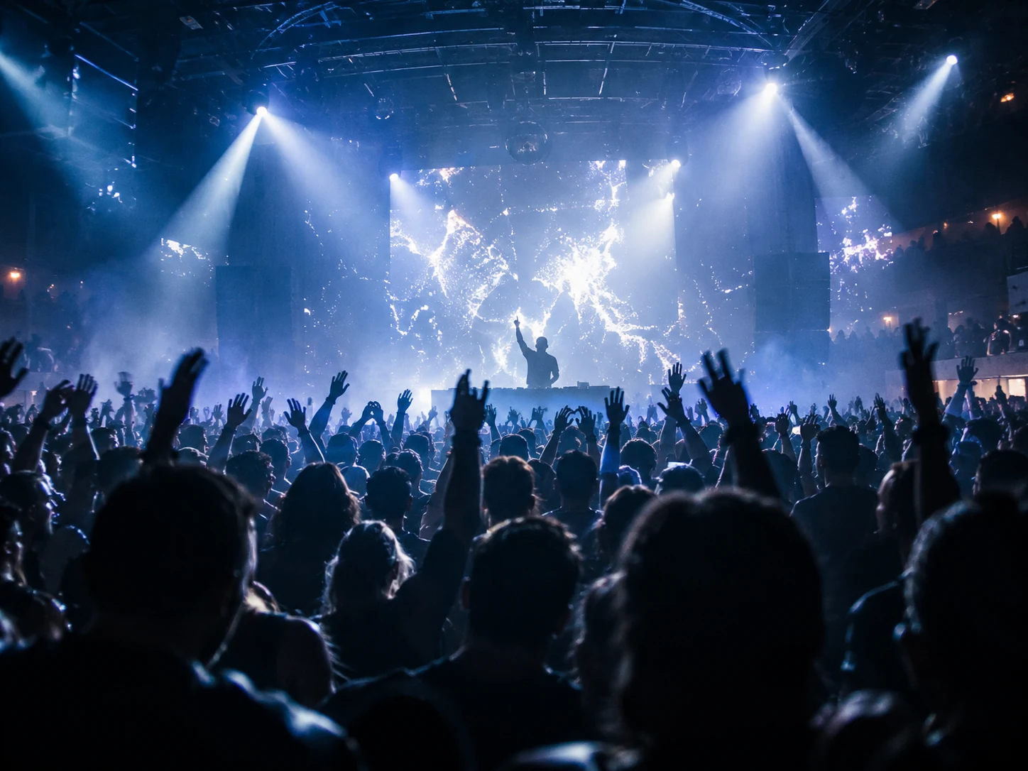 Crowd facing a large electronic music stage